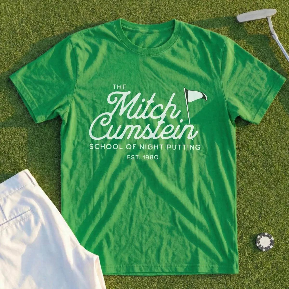 Green t-shirt with "Mitch Cumstein School of Night Putting Est. 1980" text.