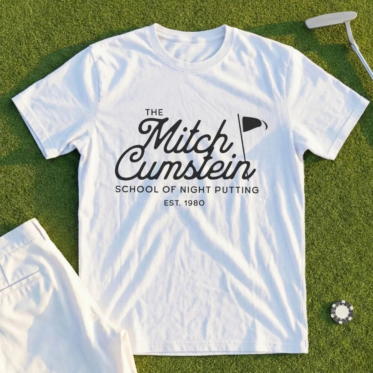 White t-shirt with "The Mitch Cumstein School of Night Putting EST. 1980" logo.