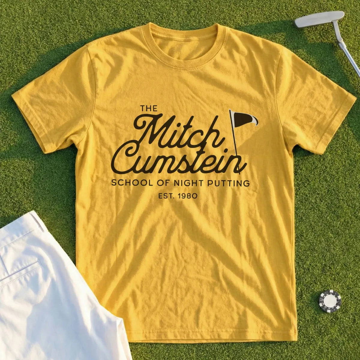 Yellow t-shirt with "The Mitch Cumstein School of Night Putting EST. 1980" text.