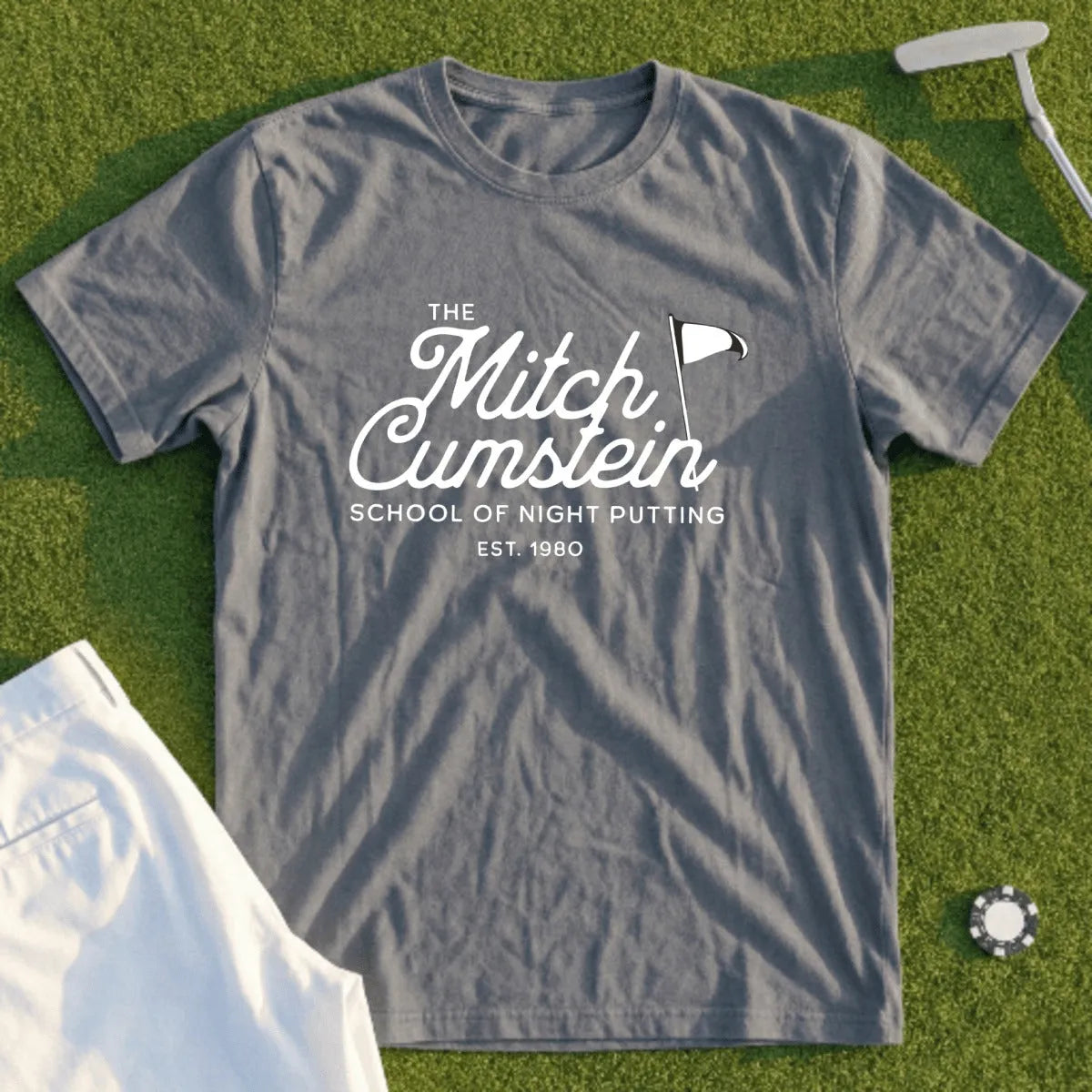 Gray t-shirt with "The Mitch Cumstein School of Night Putting" and flag logo.