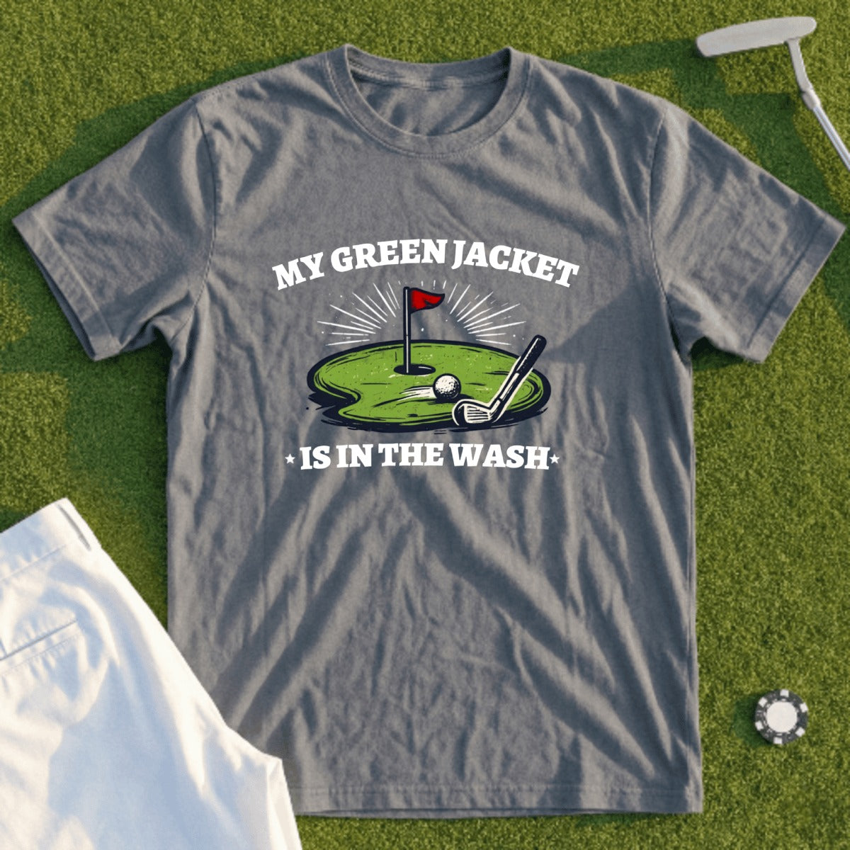 Gray t-shirt with text "MY GREEN JACKET IS IN THE WASH" and golf imagery.