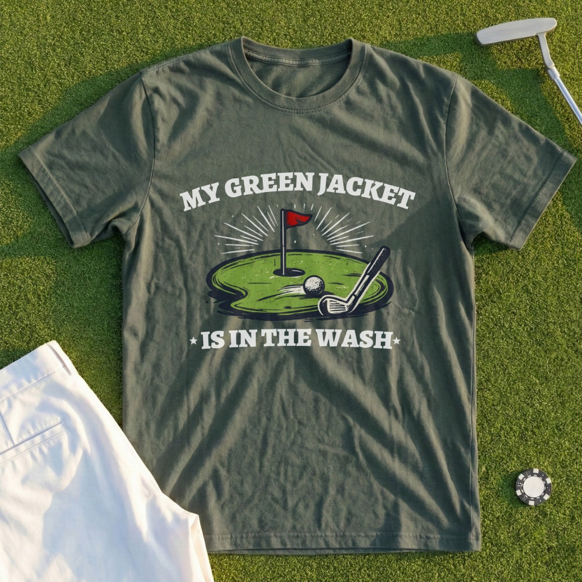 Green t-shirt with "MY GREEN JACKET IS IN THE WASH" text and golf illustration.