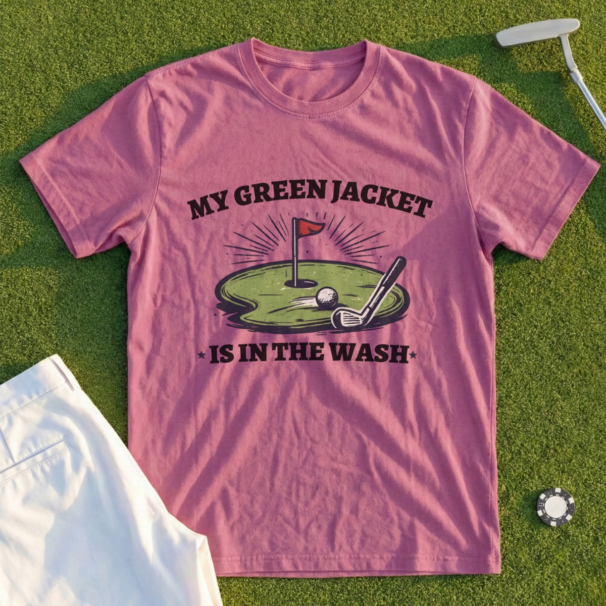 Pink t-shirt with "My Green Jacket Is In The Wash" graphic and golf imagery.