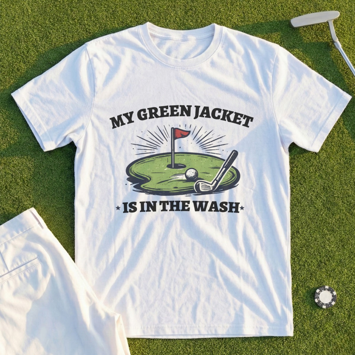 White t-shirt with "My green jacket is in the wash" text and golf graphic.