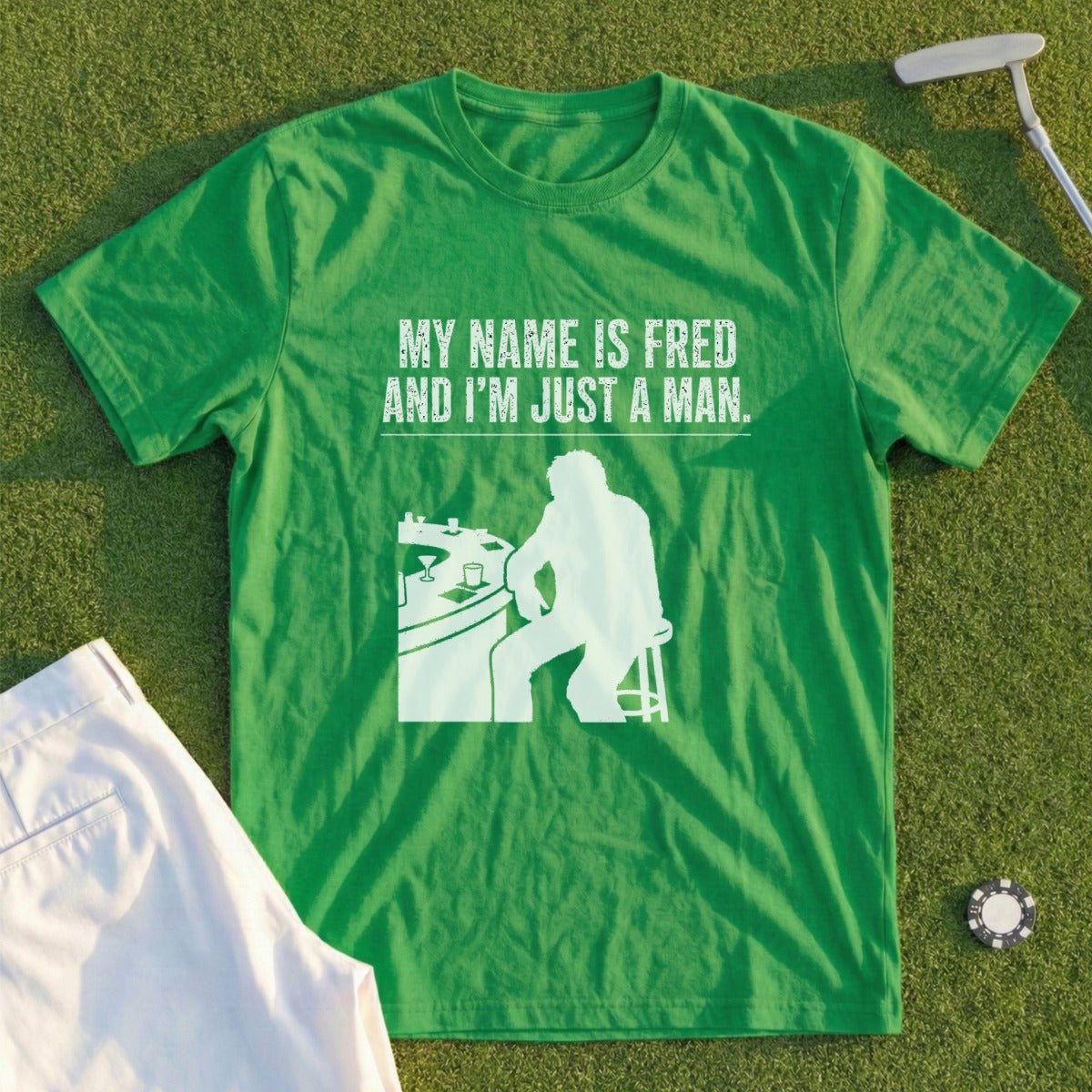 Green t-shirt with "My Name Is Fred And I'm Just A Man" graphic.
