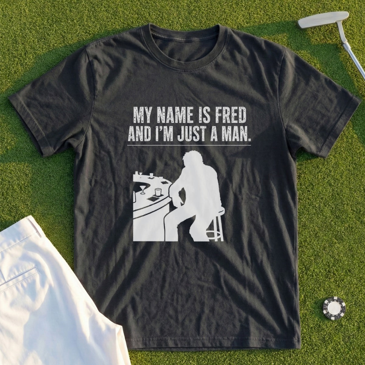 Dark t-shirt with white text and silhouette of a man at a bar.