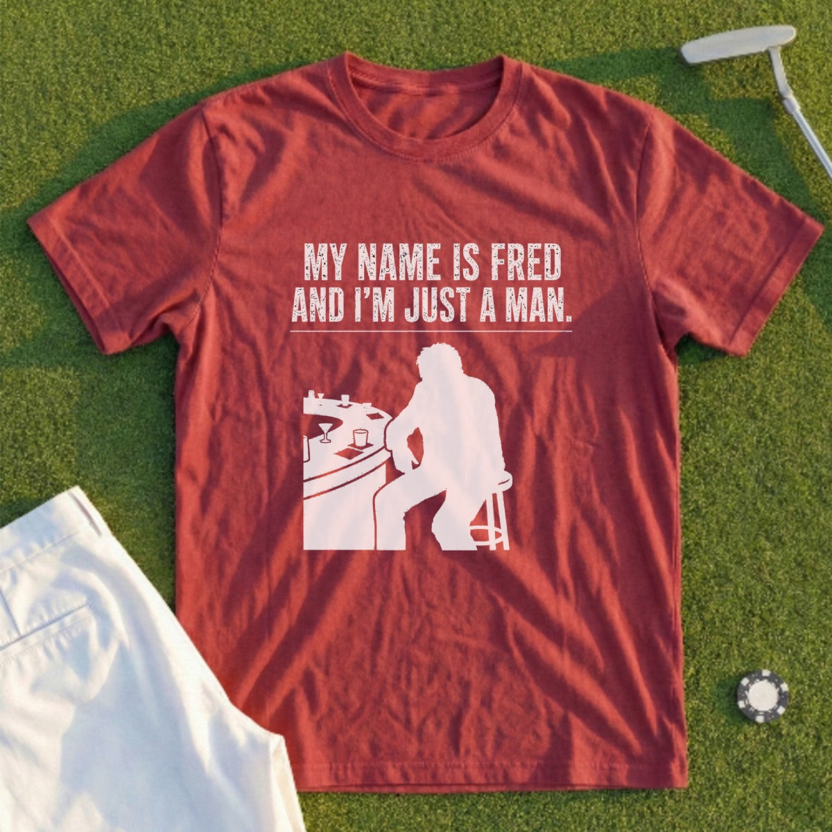 Maroon t-shirt with white text and graphic of man at bar.