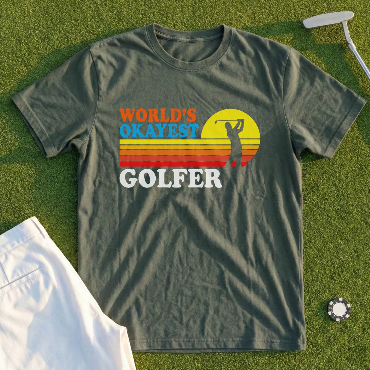 Olive green t-shirt with "World's Okayest Golfer" text and golfer silhouette.