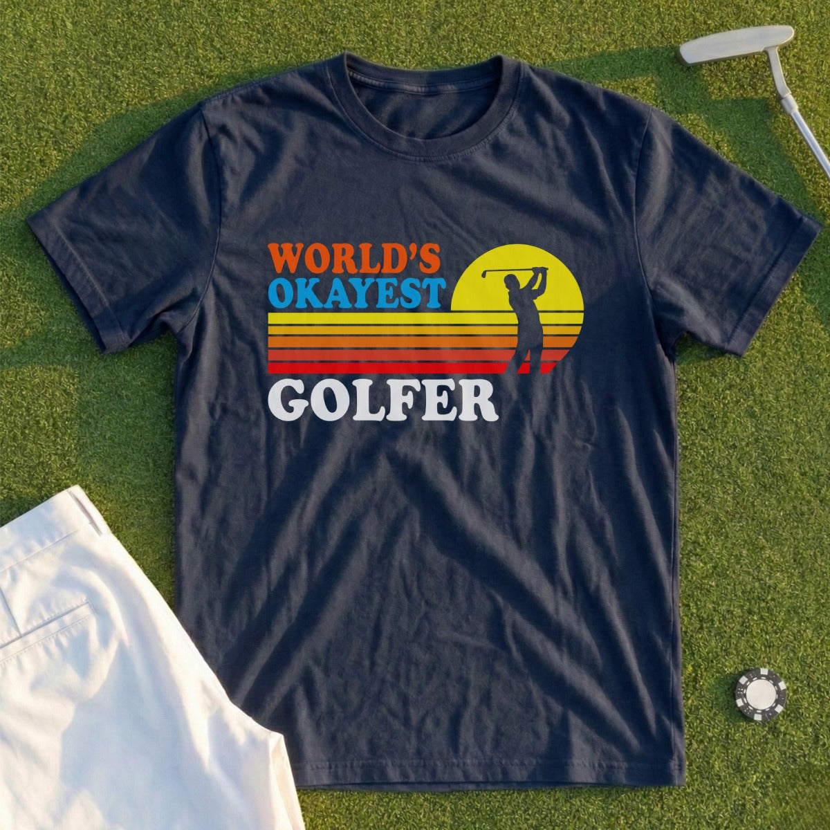 Navy t-shirt with "WORLD'S OKAYEST GOLFER" text and a golfer silhouette.