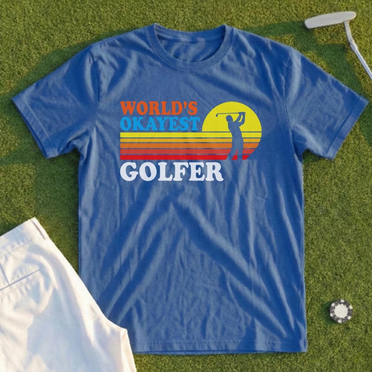 Blue t-shirt with "World's Okayest Golfer" text and a golf sunset graphic.