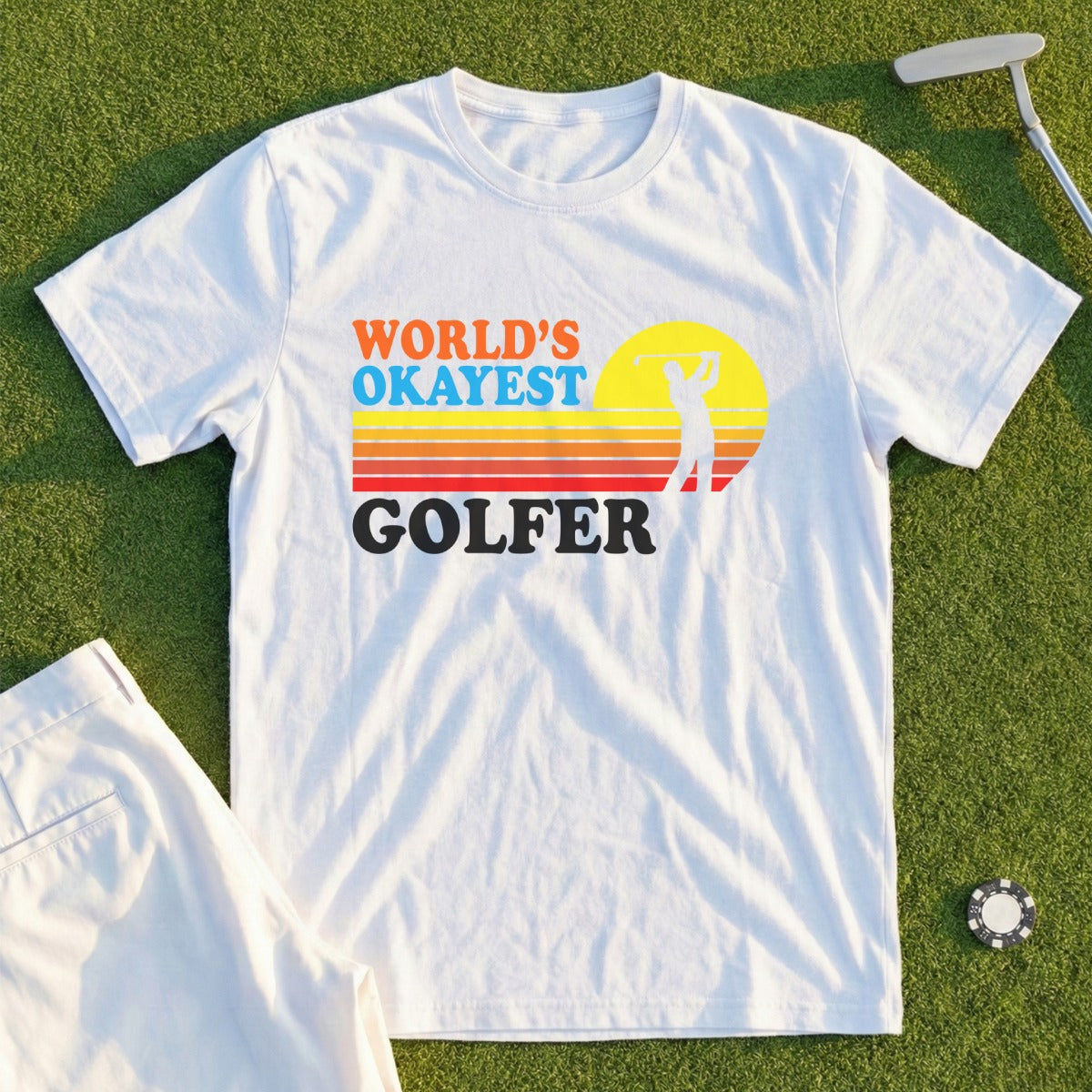 White t-shirt with "WORLD'S OKAYEST GOLFER" text and a golfer silhouette.