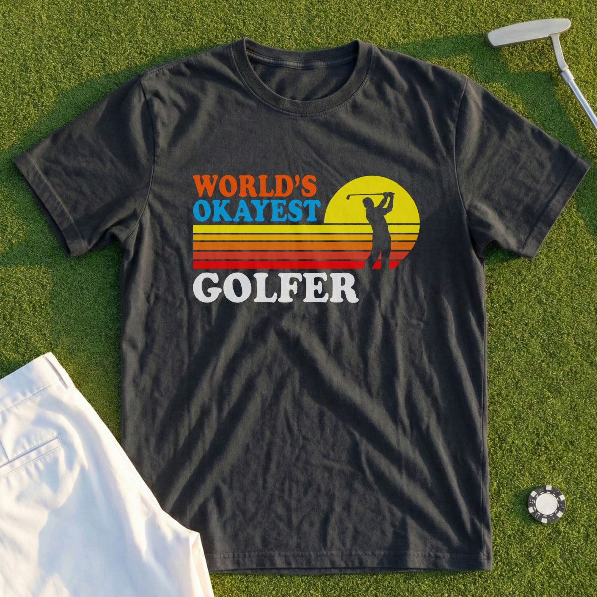 Dark t-shirt with "WORLD'S OKAYEST GOLFER" in colorful text and a golfer silhouette.