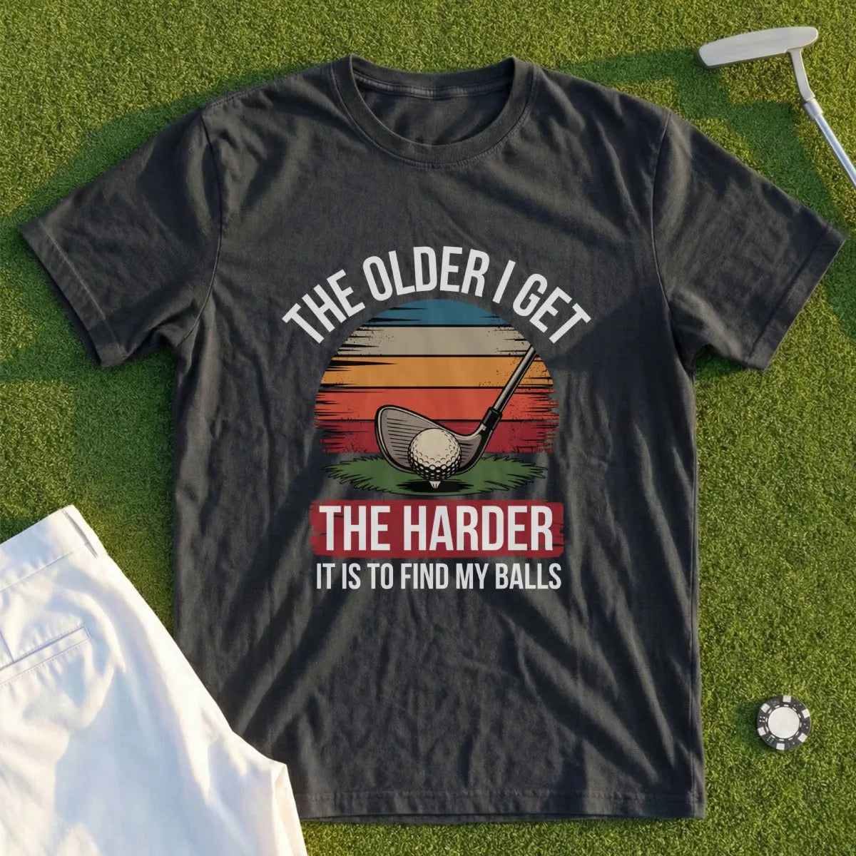 Dark t-shirt with sunset graphic and text about golf balls.
