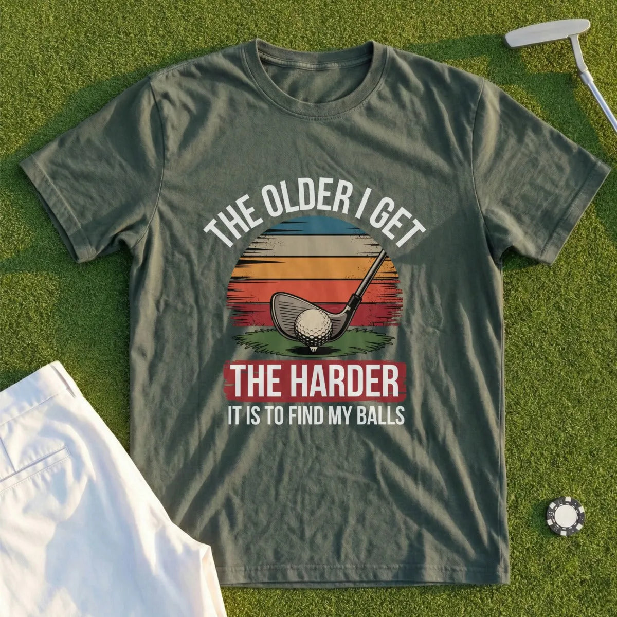 Green t-shirt with a golf club and ball, sunset graphic, and text.