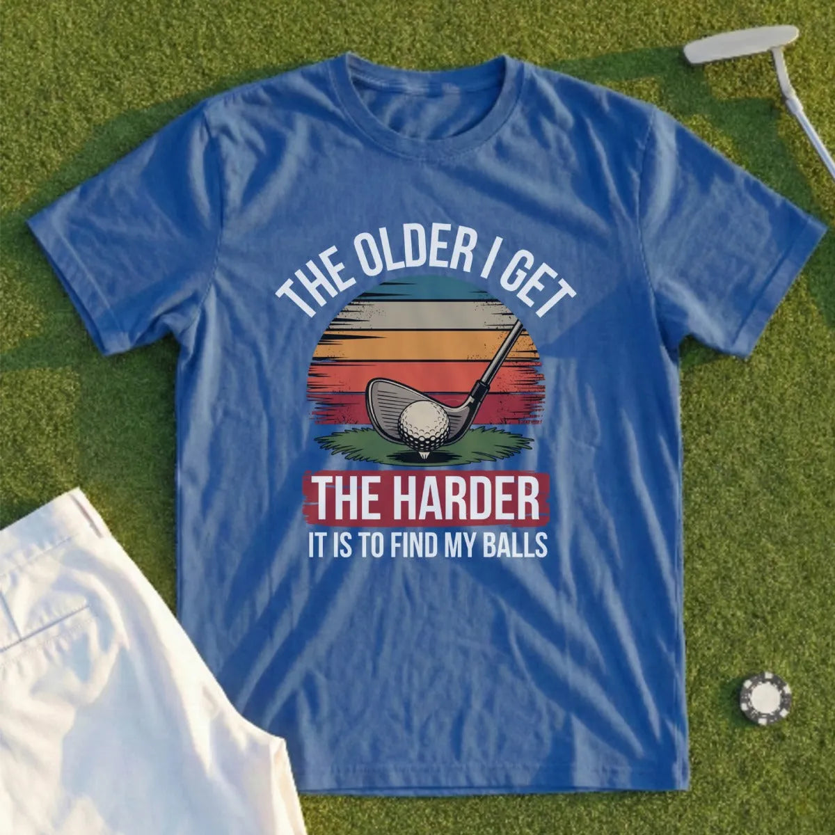 Blue t-shirt with golf club, sunset graphic, and text.
