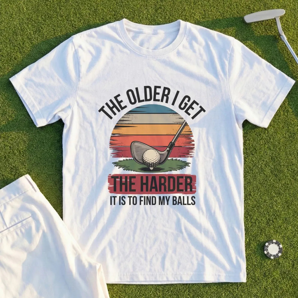 White t-shirt with "The older I get, the harder it is to find my balls" slogan and golf club graphic.