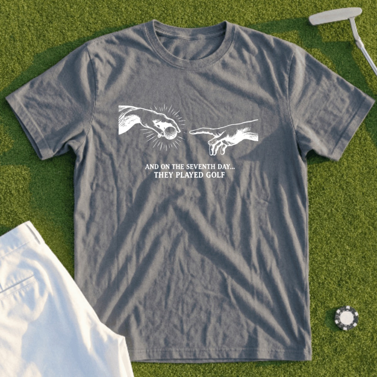 Gray t-shirt with white text "And on the seventh day... they played golf".