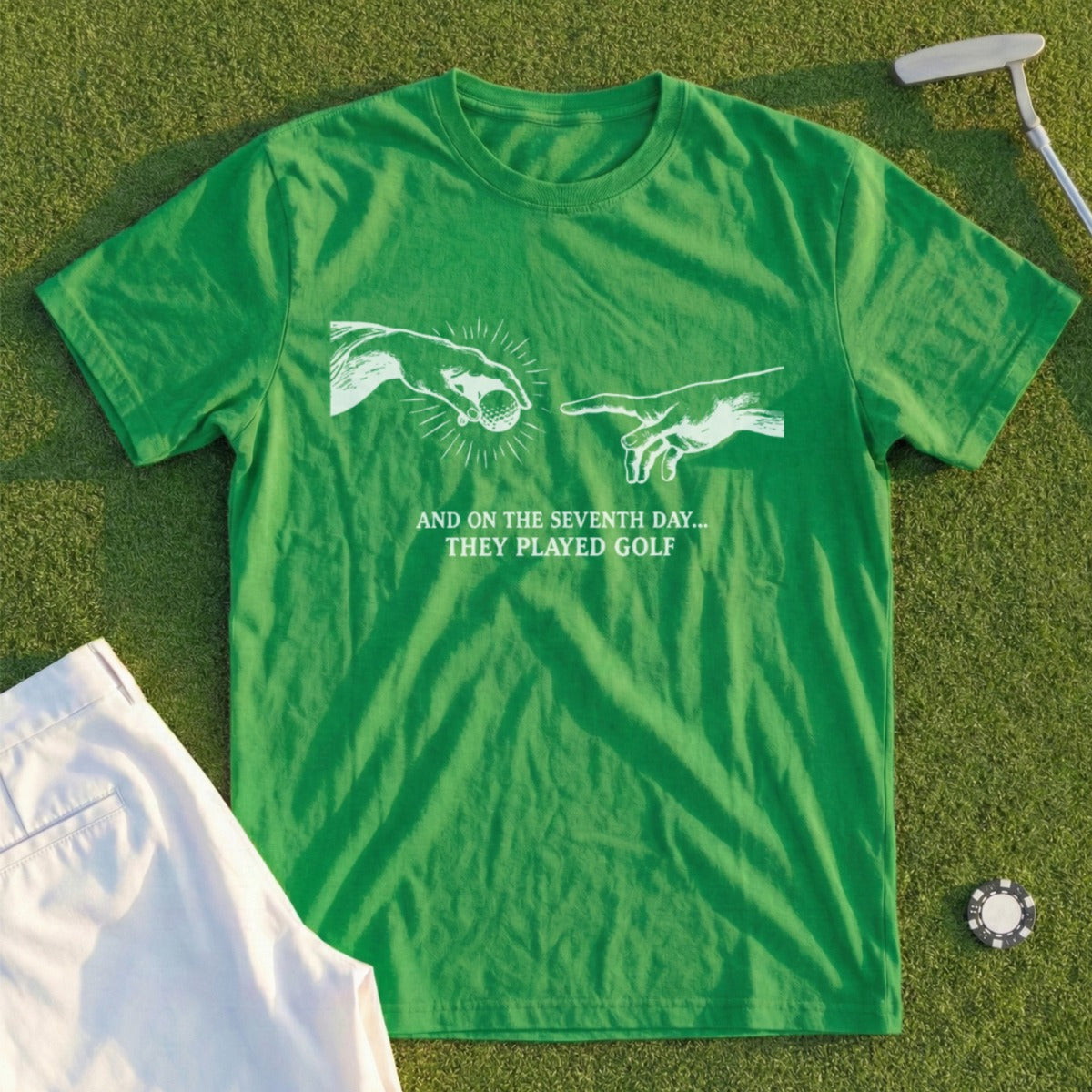 Green t-shirt with "And on the seventh day... they played golf" design.