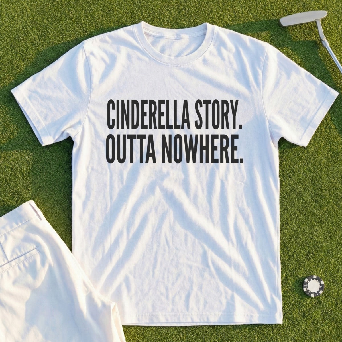 White t-shirt with "CINDERELLA STORY. OUTTA NOWHERE." printed in black text.