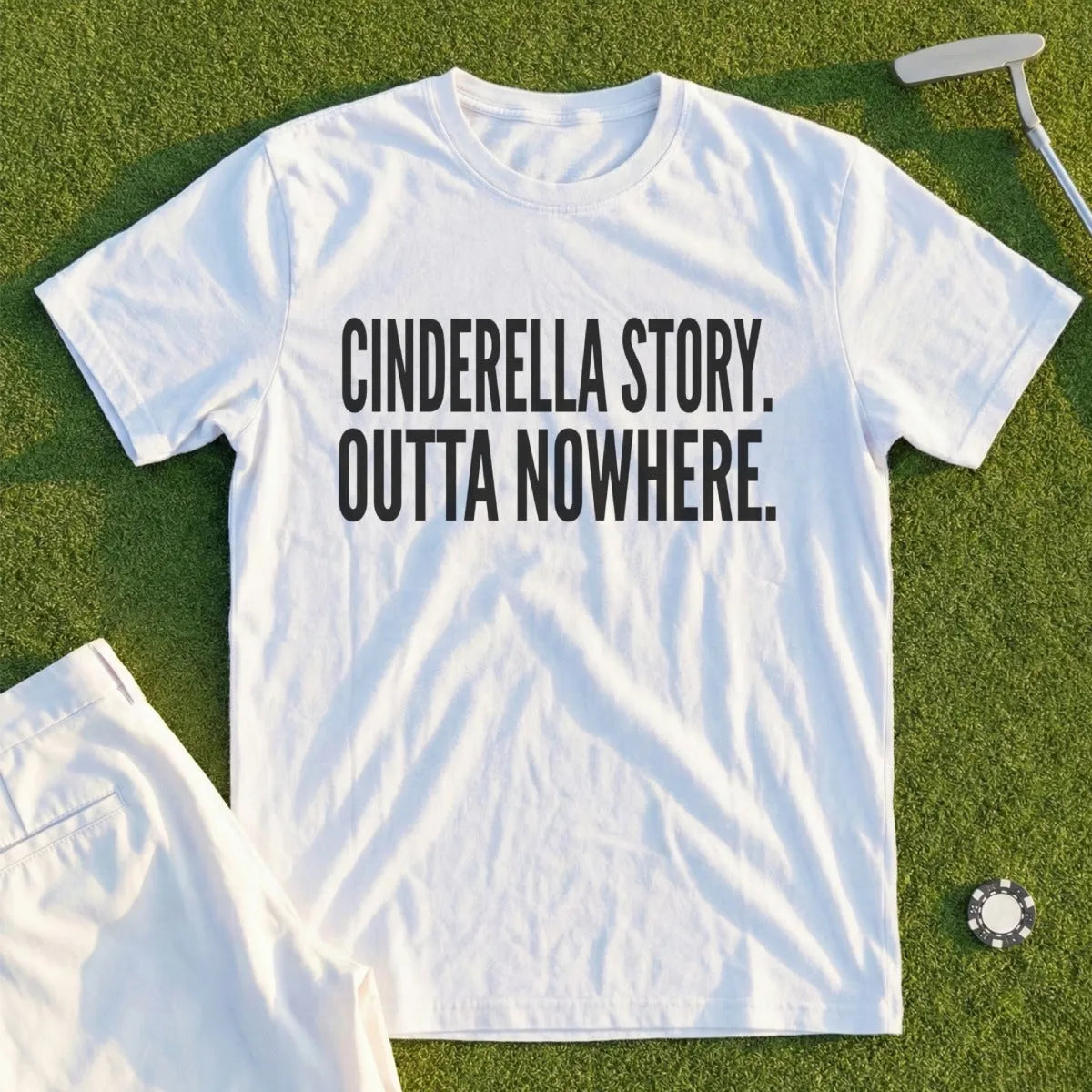 White t-shirt with "CINDERELLA STORY. OUTTA NOWHERE." printed in black text.