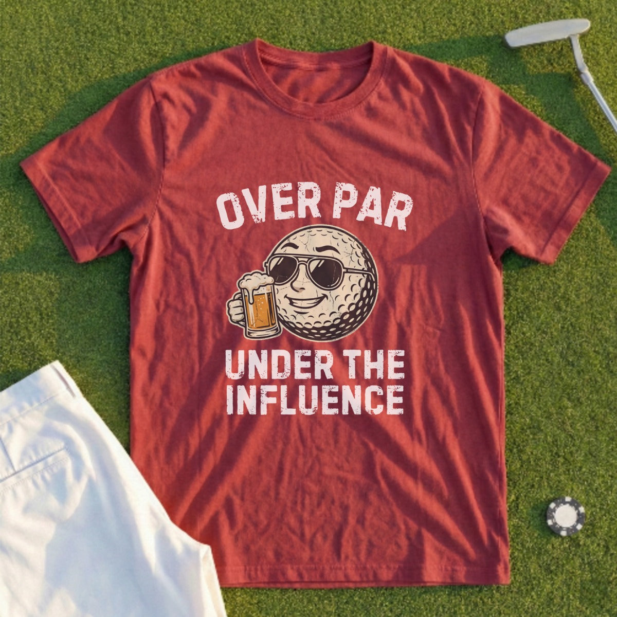 Maroon t-shirt with graphic of a sunglasses-wearing golf ball holding a beer, reading "OVER PAR UNDER THE INFLUENCE."