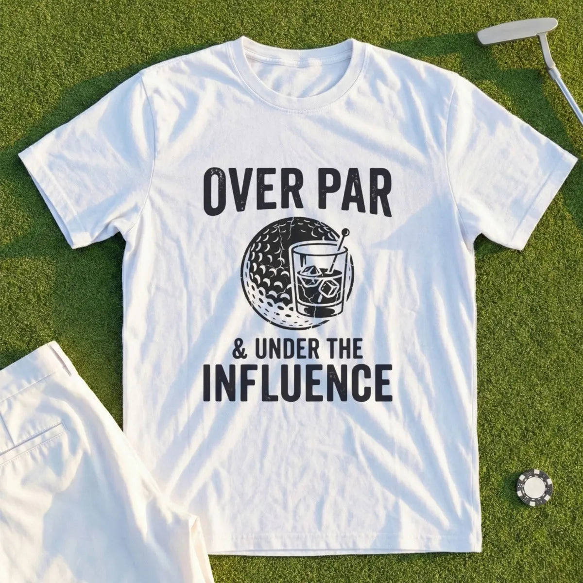 White t-shirt with "OVER PAR & UNDER THE INFLUENCE" text and golf ball graphic.