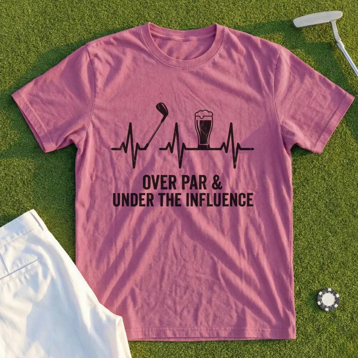 Pink t-shirt with golf club, beer, and heartbeat graphic above text "Over Par & Under the Influence".