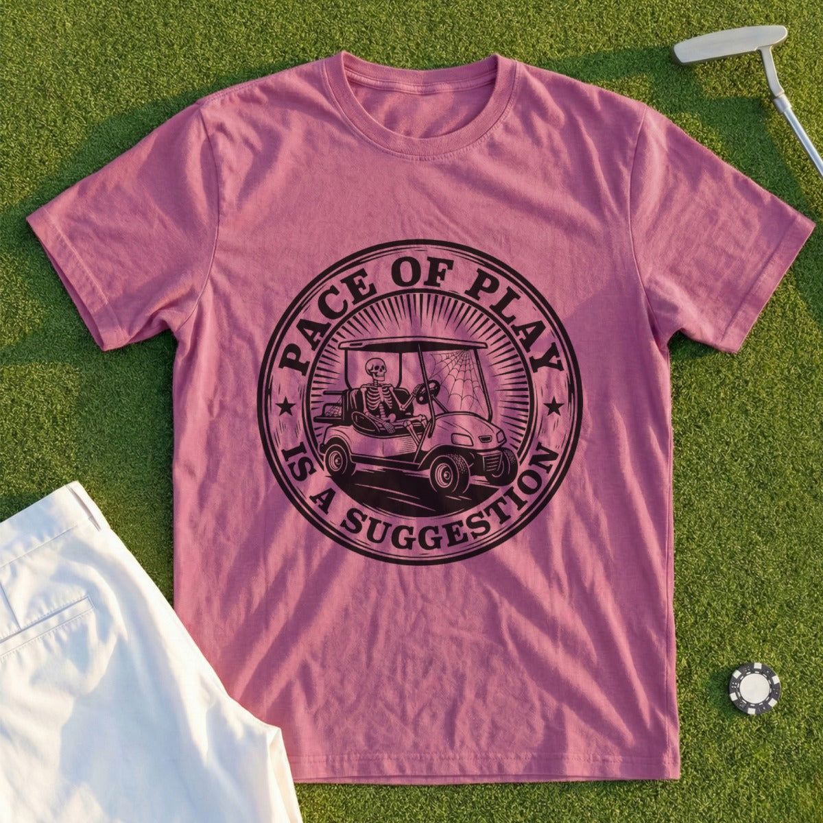 Pink t-shirt with skeleton in golf cart graphic, "Pace of Play is a Suggestion".