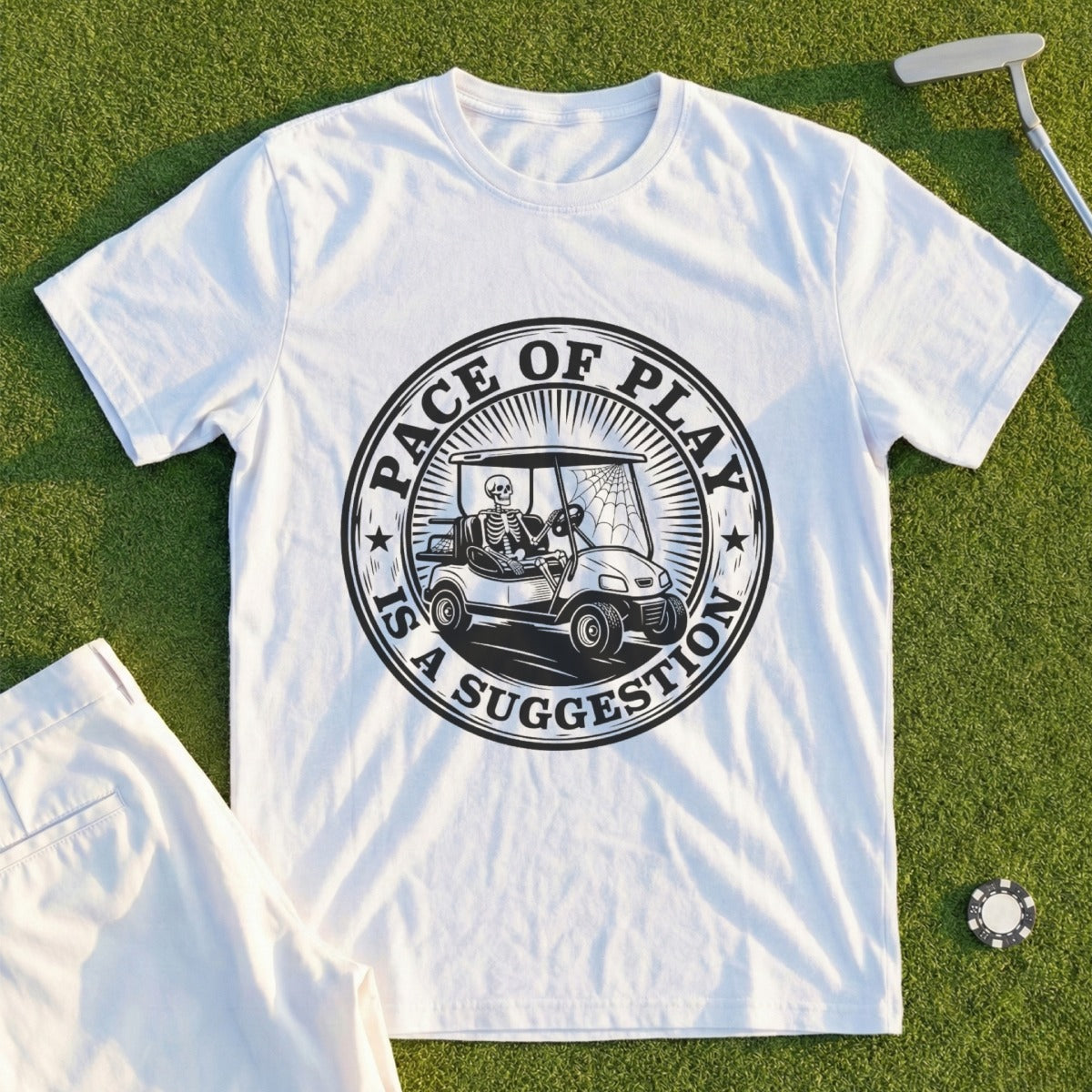 White t-shirt with circular graphic: skeleton driving a golf cart.