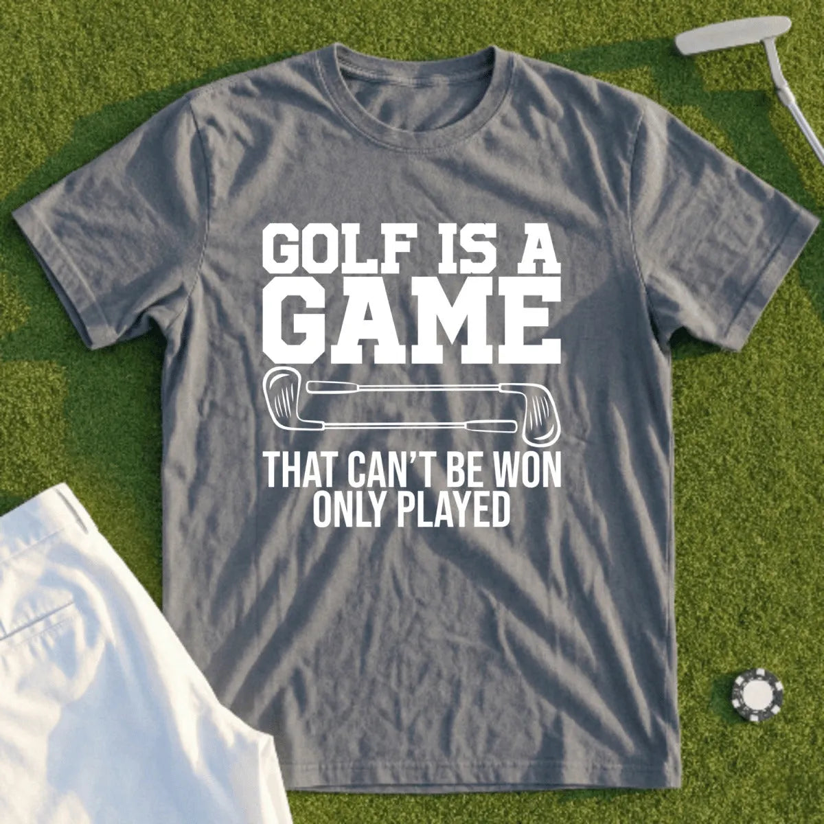 Grey t-shirt with "Golf is a game that can't be won only played" text.