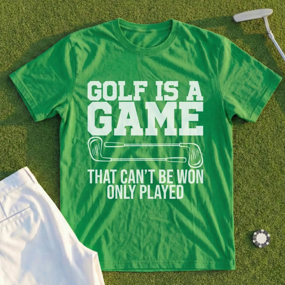 Green t-shirt with "GOLF IS A GAME THAT CAN'T BE WON ONLY PLAYED" text.