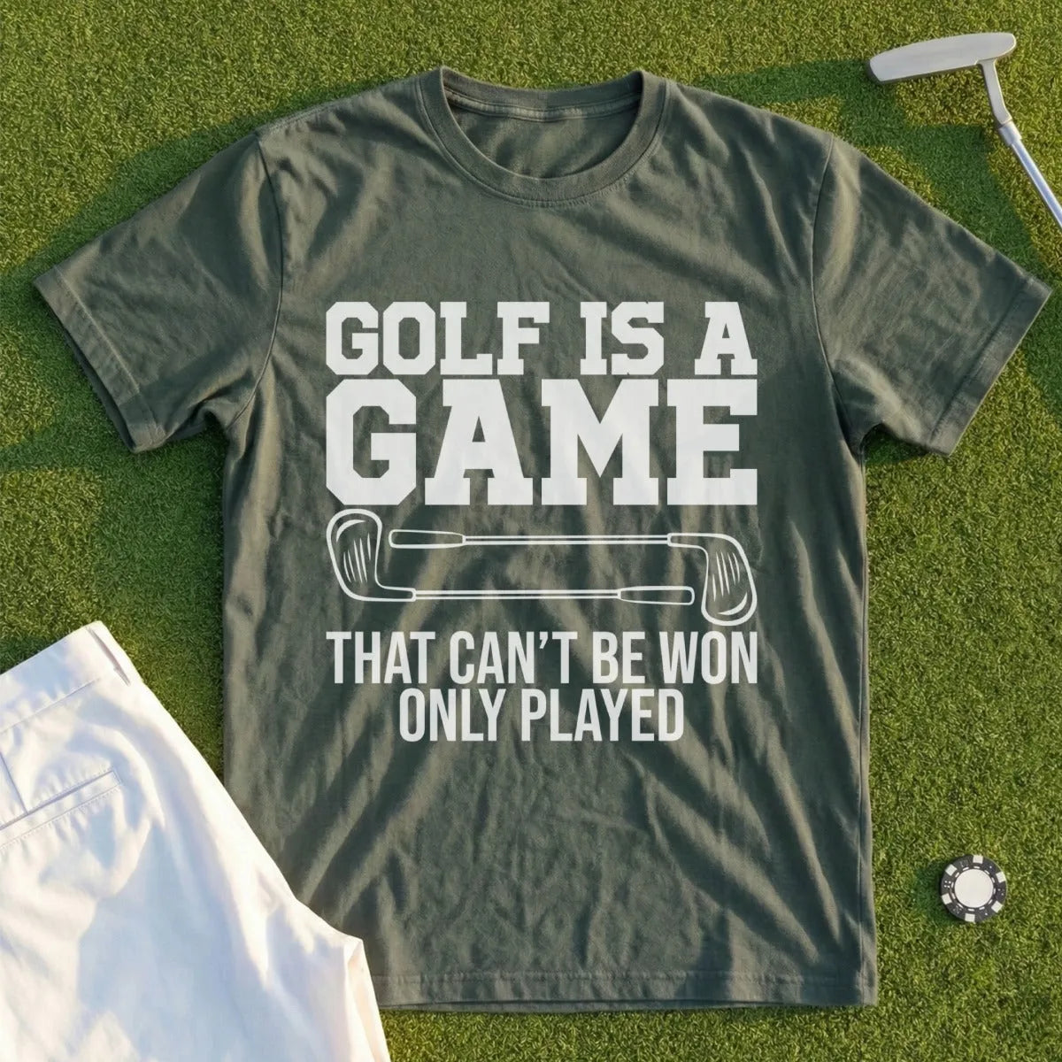 Green t-shirt with "Golf is a game that can't be won only played" text.