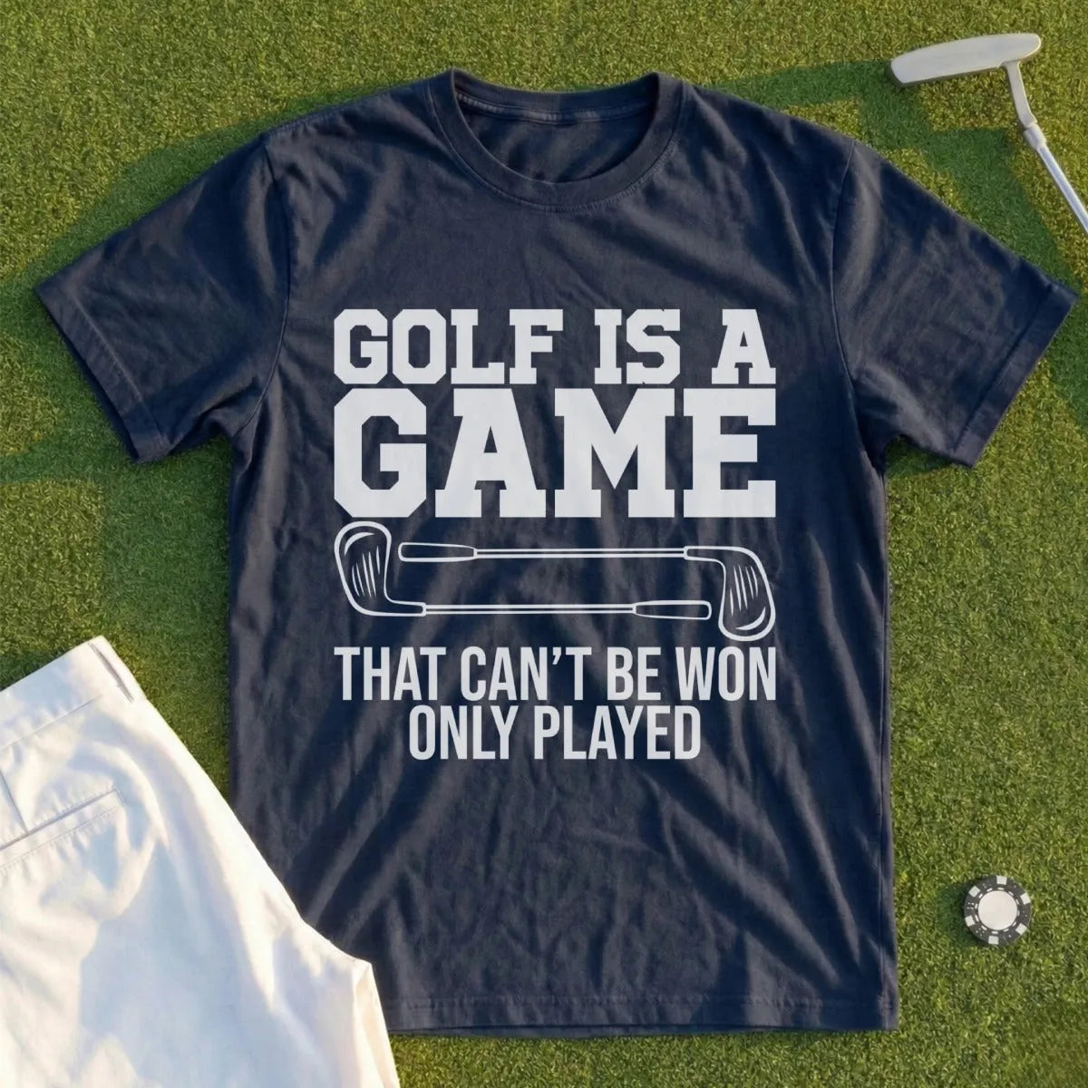 Dark blue t-shirt with white text "GOLF IS A GAME THAT CAN'T BE WON ONLY PLAYED".