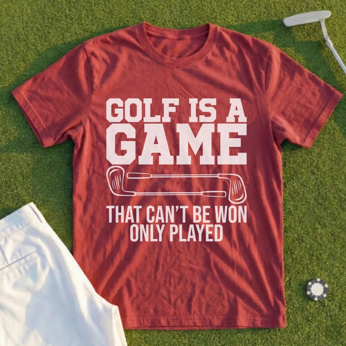 Maroon t-shirt with "Golf is a game that can't be won only played."