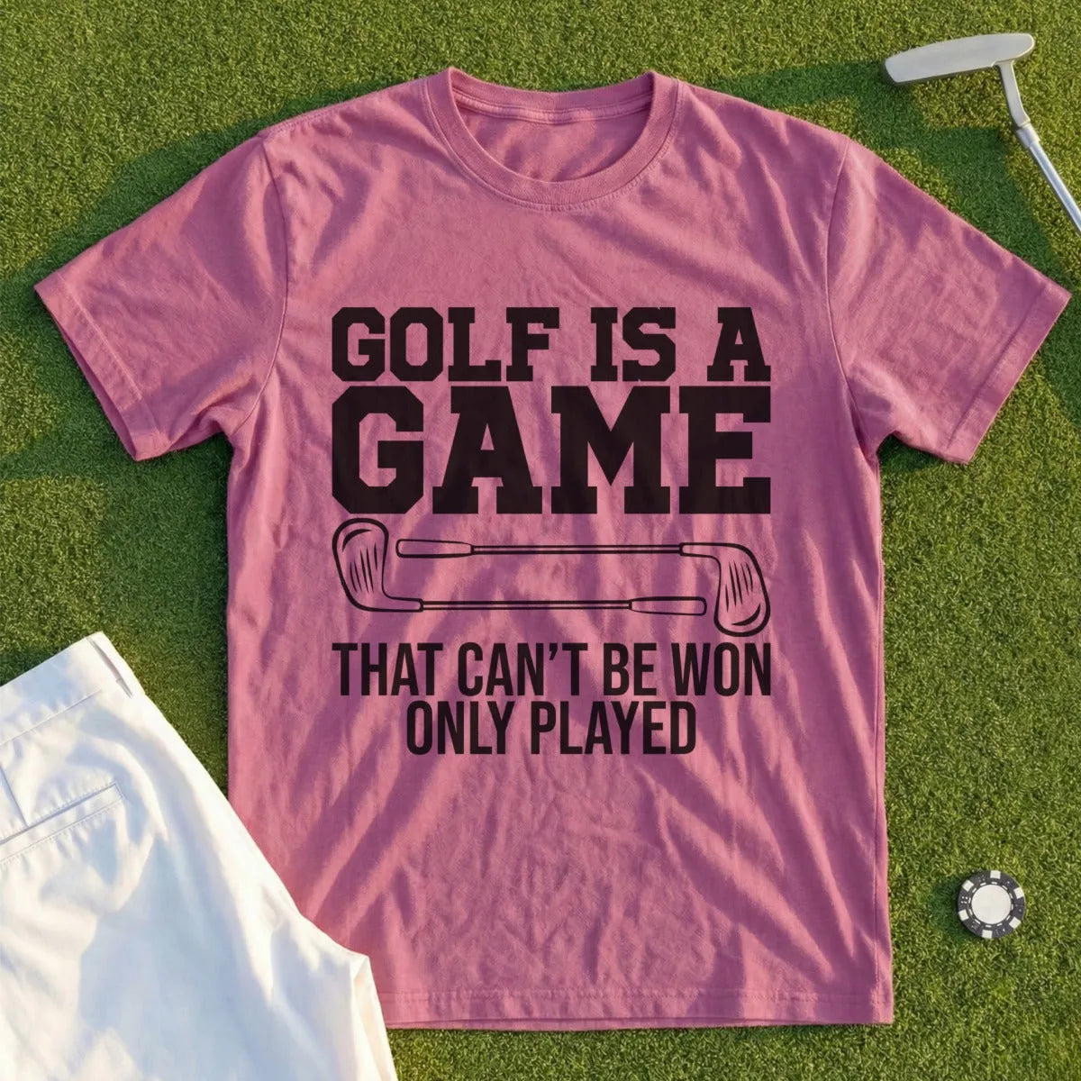 Pink t-shirt with "GOLF IS A GAME THAT CAN'T BE WON ONLY PLAYED" text.