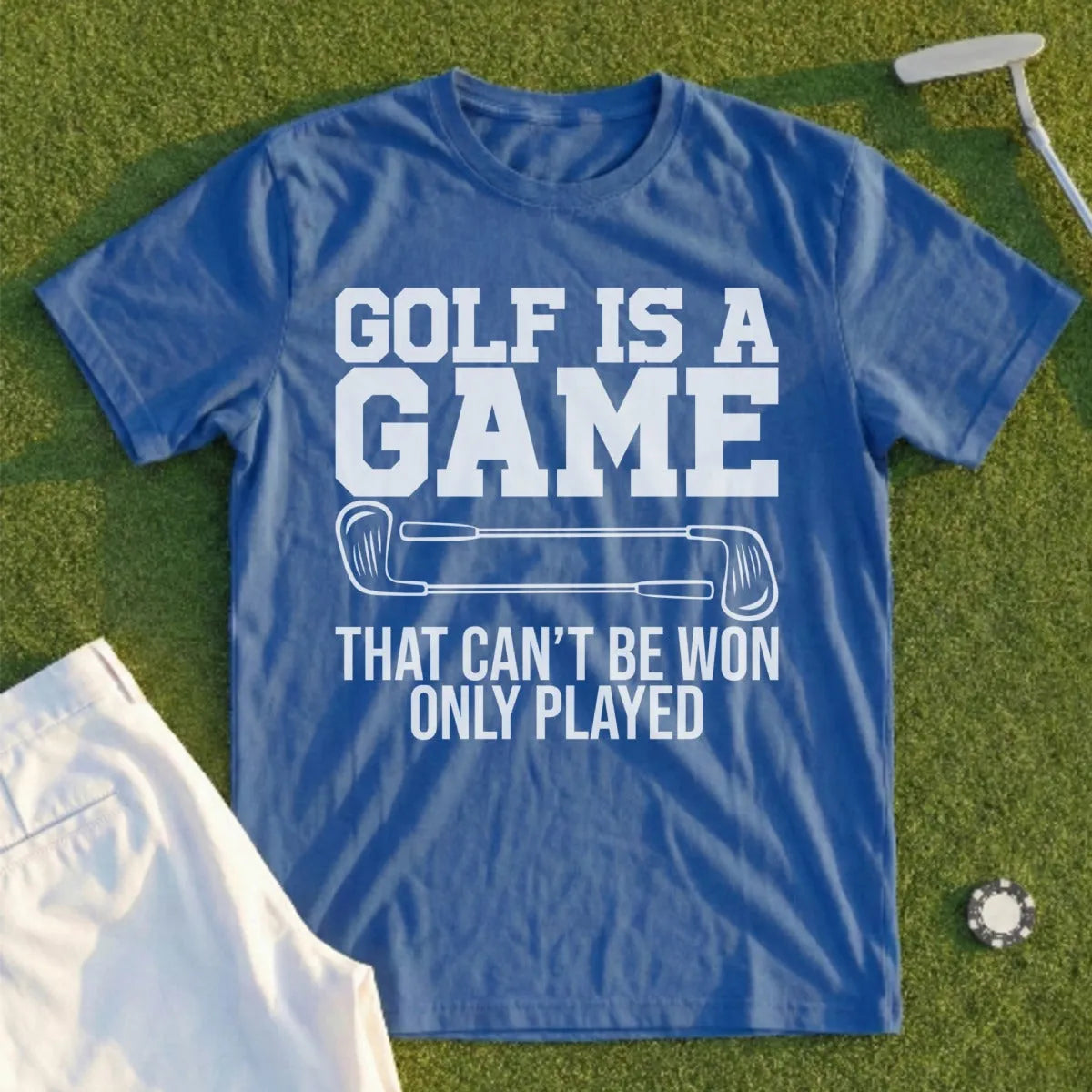 Blue t-shirt with "Golf is a game that can't be won only played" text.
