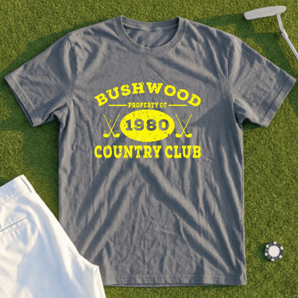 Grey t-shirt with yellow "Bushwood Country Club 1980" text and crossed golf clubs.