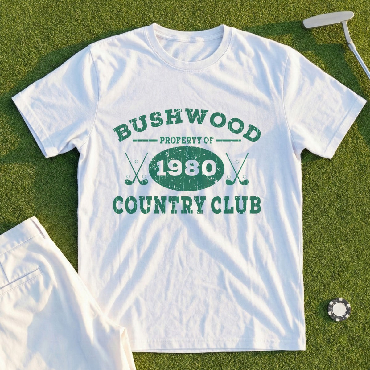 White t-shirt with "Bushwood Country Club 1980" graphic and crossed golf clubs.