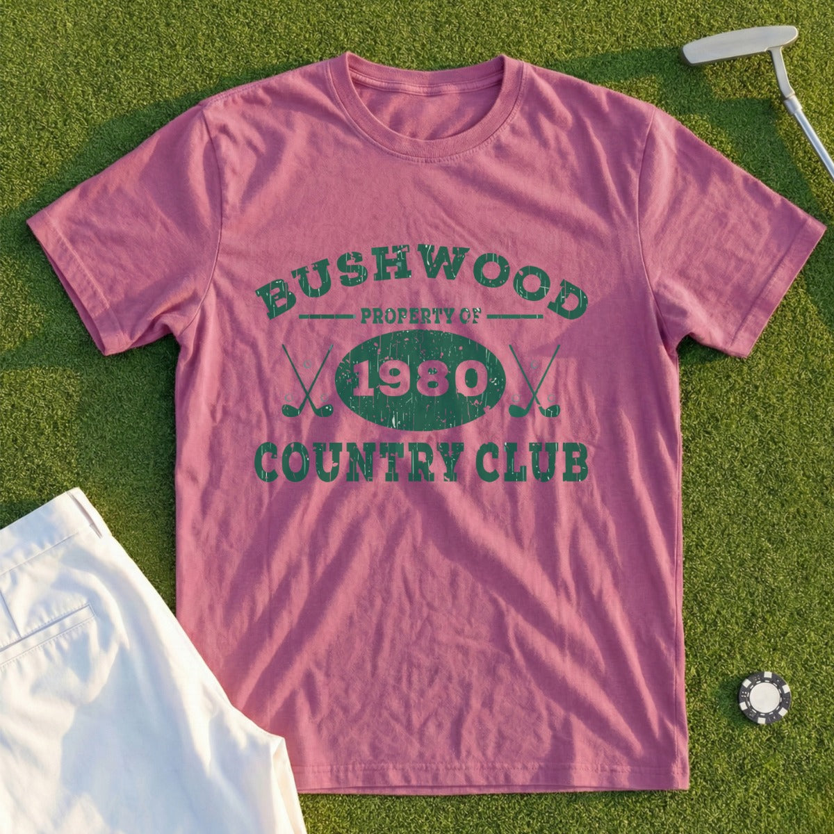 Bushwood Country Club 1980 t-shirt with golf accessories on grass.