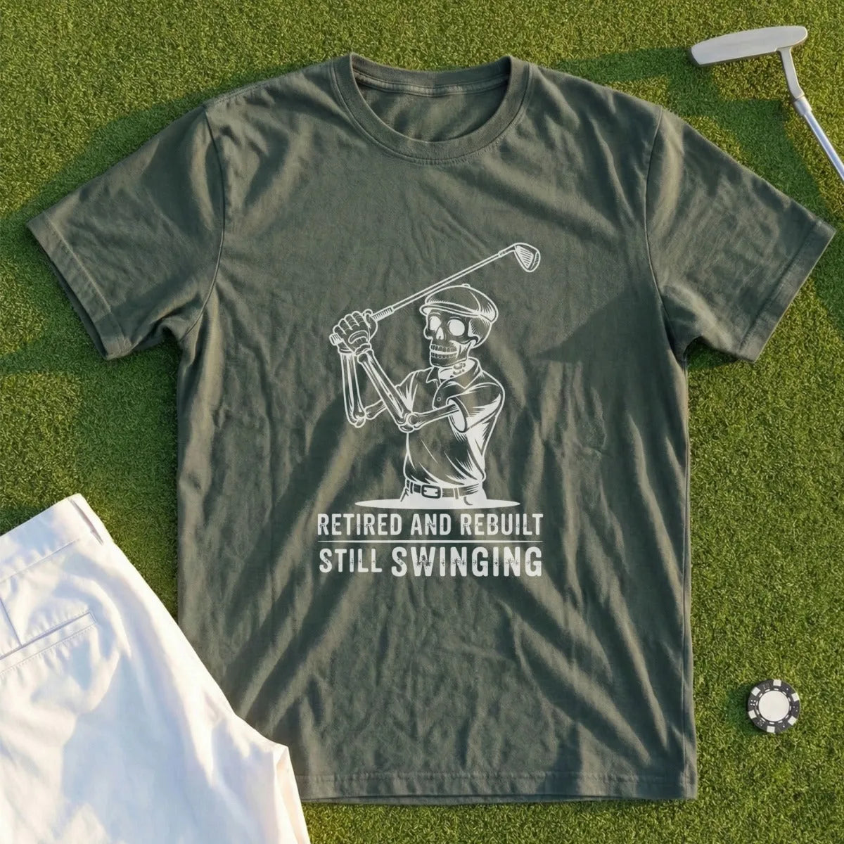 Skeleton golfer wearing a t-shirt that says "Retired and Rebuilt Still Swinging".