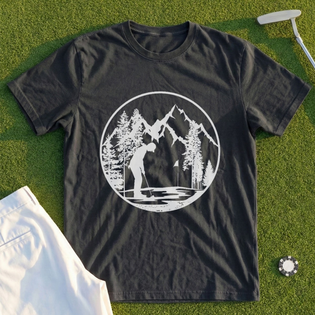Dark t-shirt with white circular graphic of a golfer, mountains, and trees.
