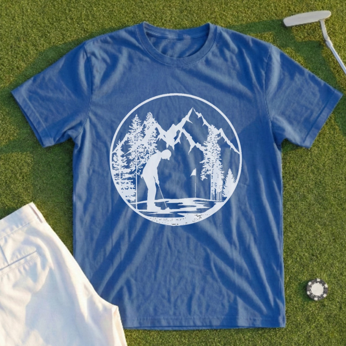 Blue t-shirt with white circular graphic of golfer, mountains, and trees.