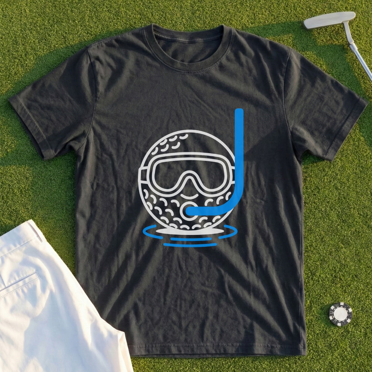 Dark t-shirt with a graphic of a golf ball wearing snorkeling gear on grass.