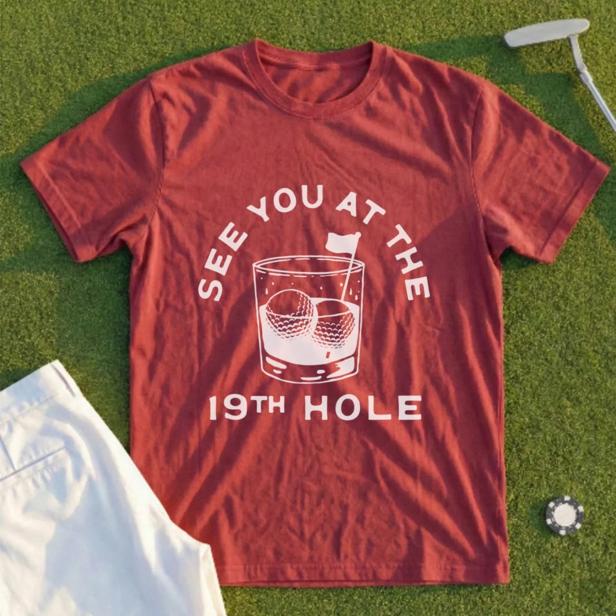 T-shirt with "See You At The 19th Hole" text and golf ball whiskey glass graphic.