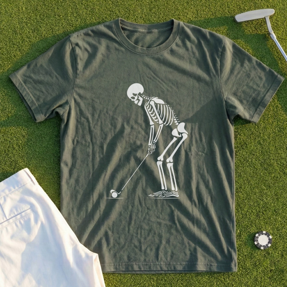 Skeleton golfing on a green t-shirt.