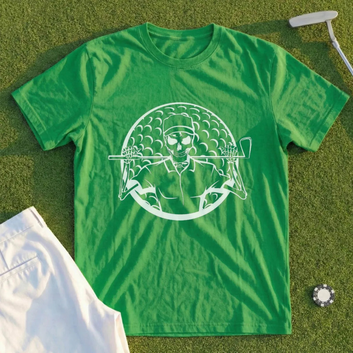 Green t-shirt with white graphic of a skeleton golfer on a golf course.