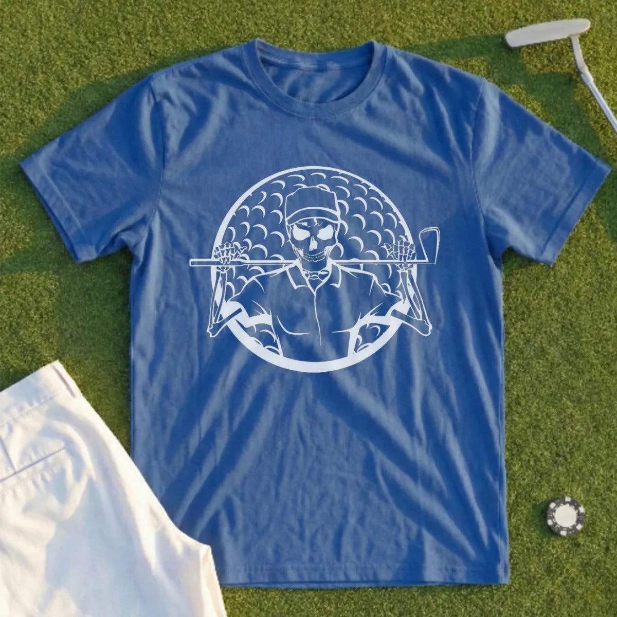 Blue t-shirt with white skeleton golfer graphic and golf ball pattern.