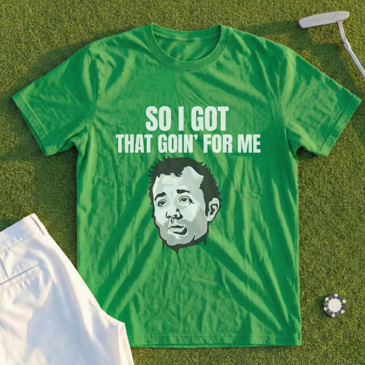 Green t-shirt with "SO I GOT THAT GOIN' FOR ME" text and a portrait of a man.