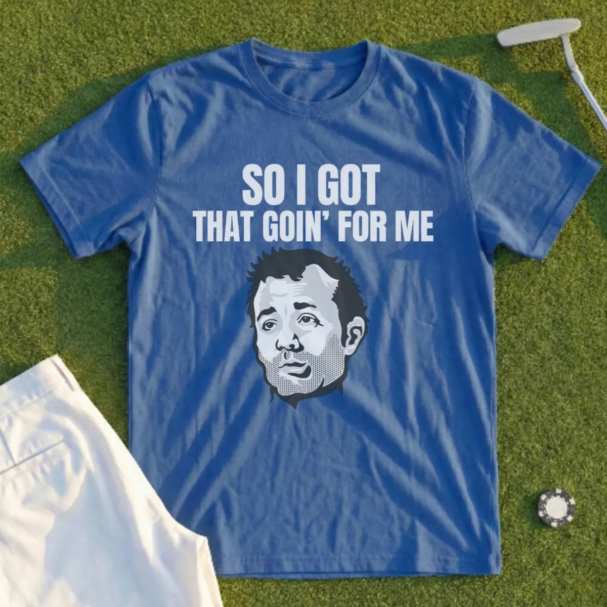 Blue t-shirt with text "SO I GOT THAT GOIN' FOR ME" and a cartoon face.