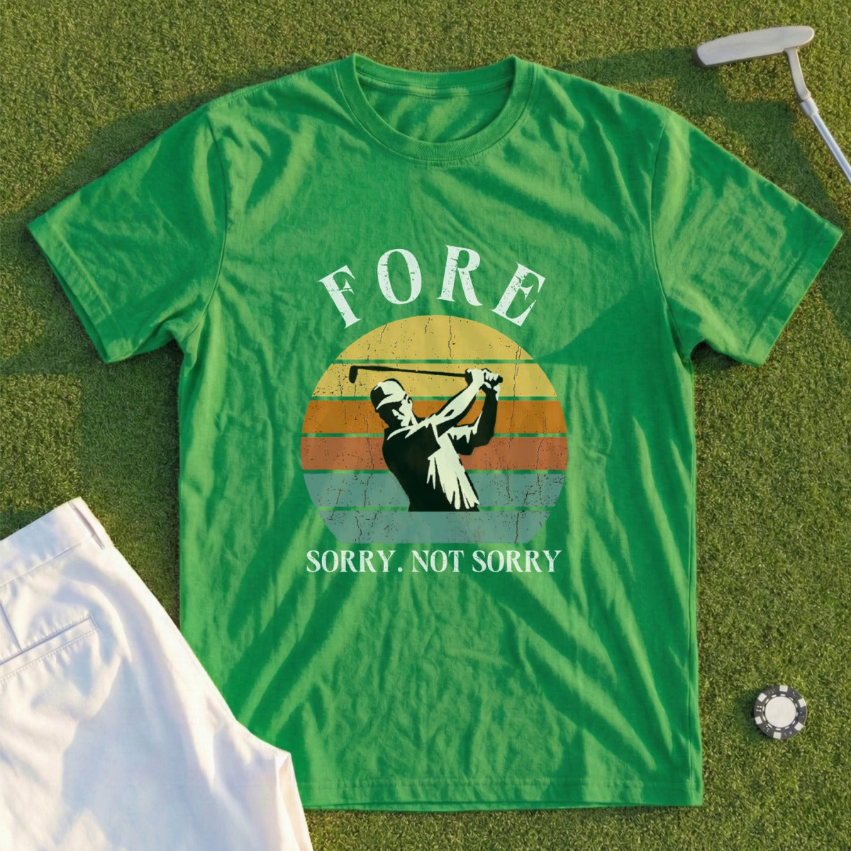 Green t-shirt with golfer silhouette and "Fore. Sorry. Not Sorry." text.